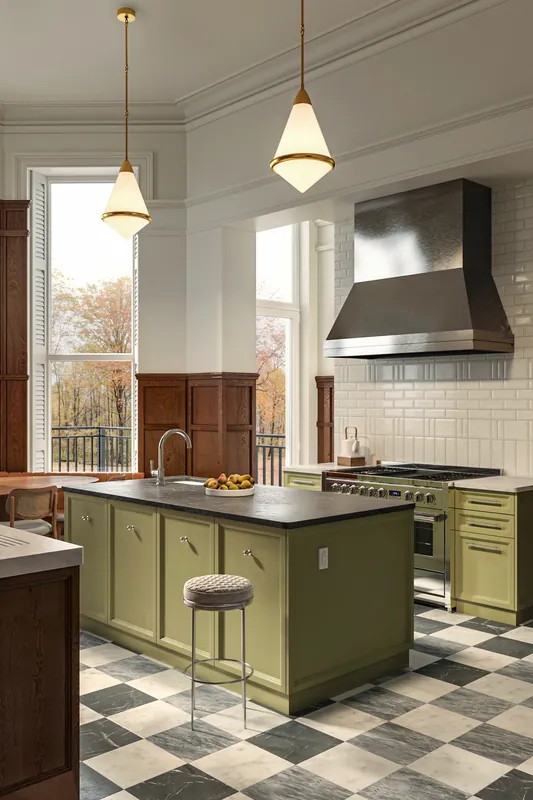 Kitchen corner with stainless range hood and subway tile