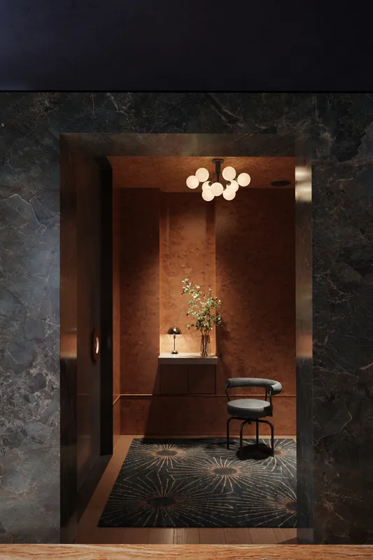 Restaurant entry with marble walls and sculptural lighting